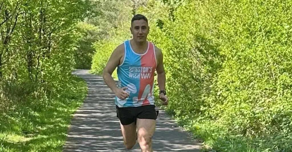 Gareth running in the park, training for the London Marathon as he wears Winston's Wish running vest