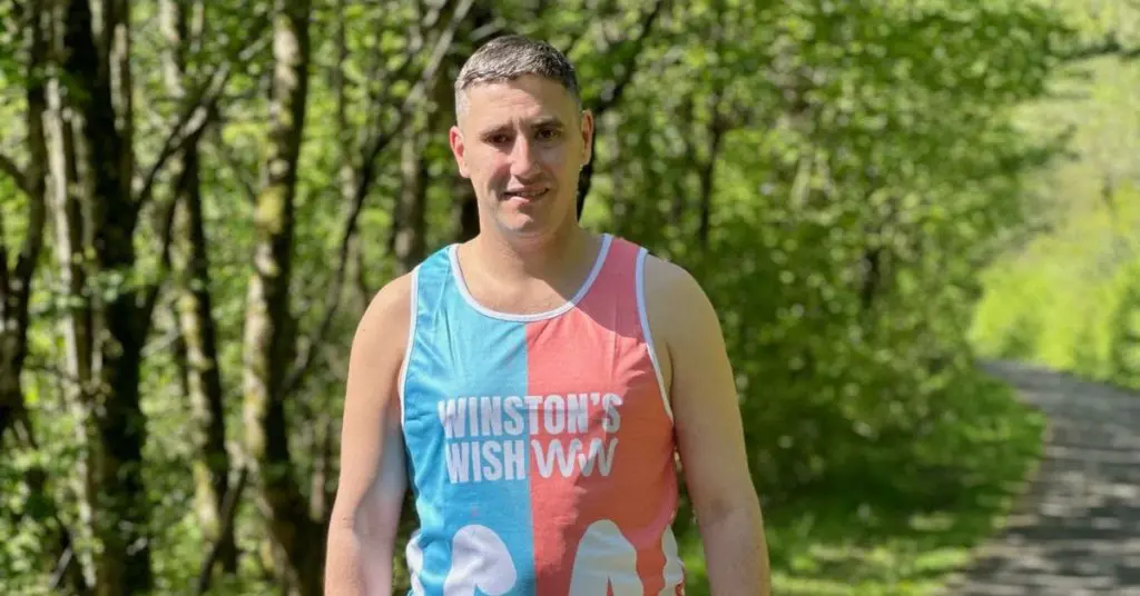 Gareth Evans standing in a park wearing a Winston's Wish running vest