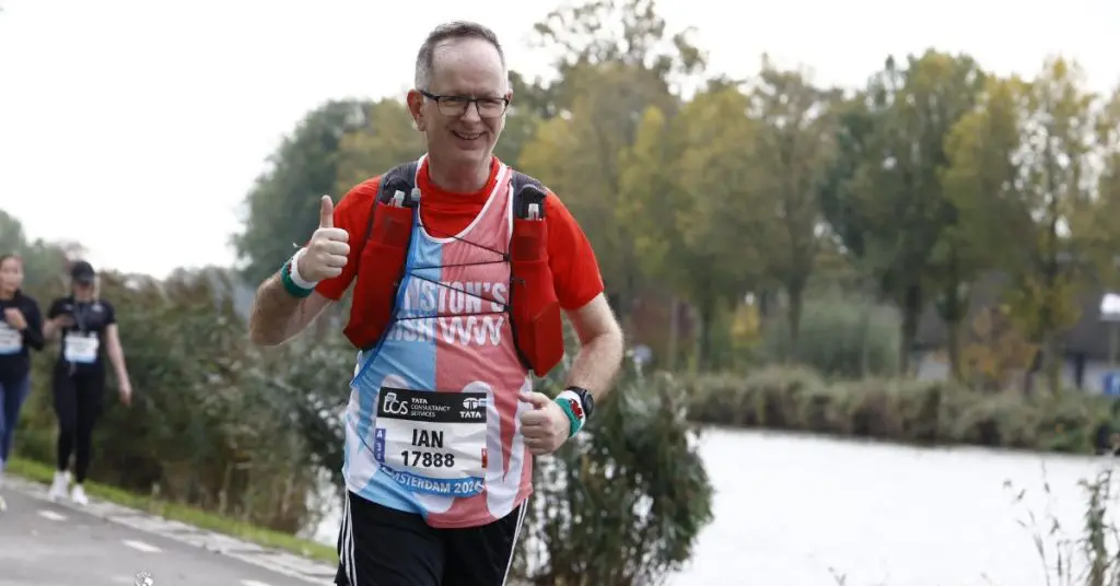 Ian running the Amsterdam Marathon wearing a Winston's Wish running vest