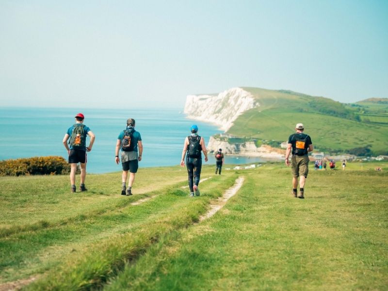 People walking along the Isle of Wight coast