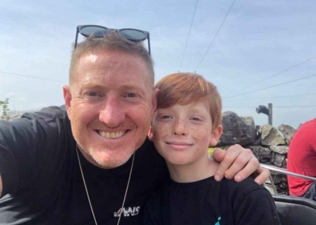 Fundraiser George with his son as he prepares for his 65-mile walking challenge