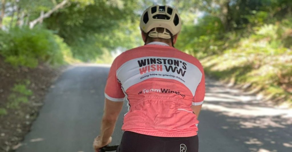 James Beeson cycling roadside during his 1,000 mile challenge
