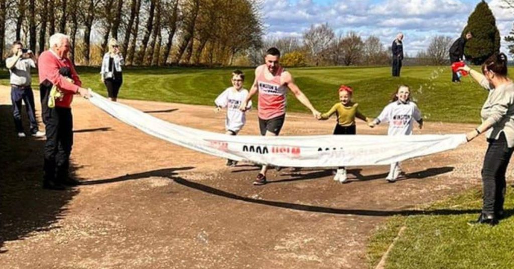 James crossing the finish line with his niece, nephew and daughter while wearing Winston's Wish t-shirts