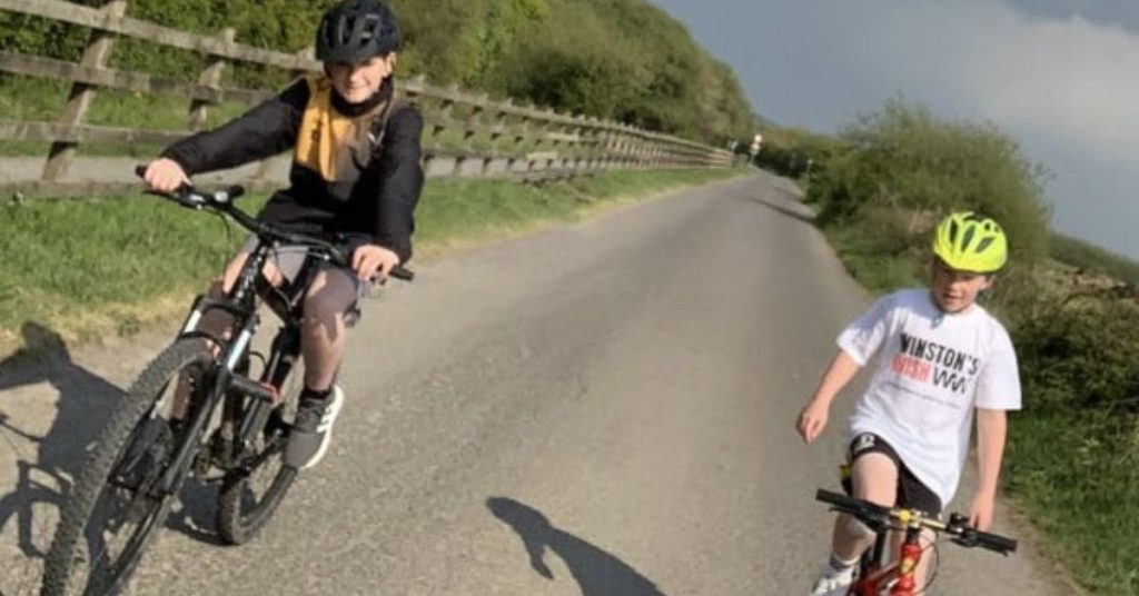Sam and Thomas on their cycle ride down a country path