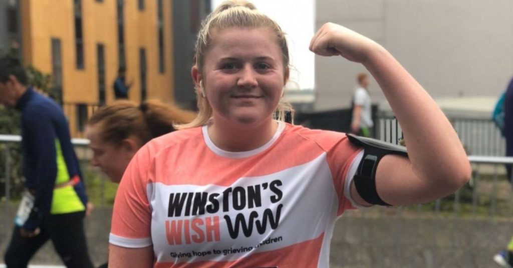 Winston's Wish runner, flexing her bicep to the camera