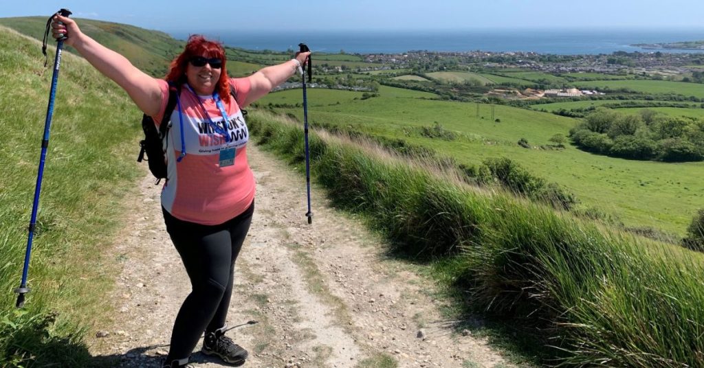 Winston's Wish supporter celebrating mid-trek with her walking poles