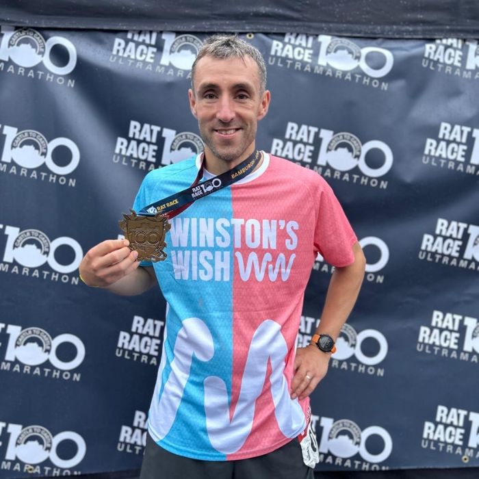 Winston's Wish supporter, Tom Clarke at the finish line of the 100 Mile Marathon in his Winston's Wish running vest
